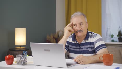 Home-office-worker-old-man-thinking-looking-at-camera.